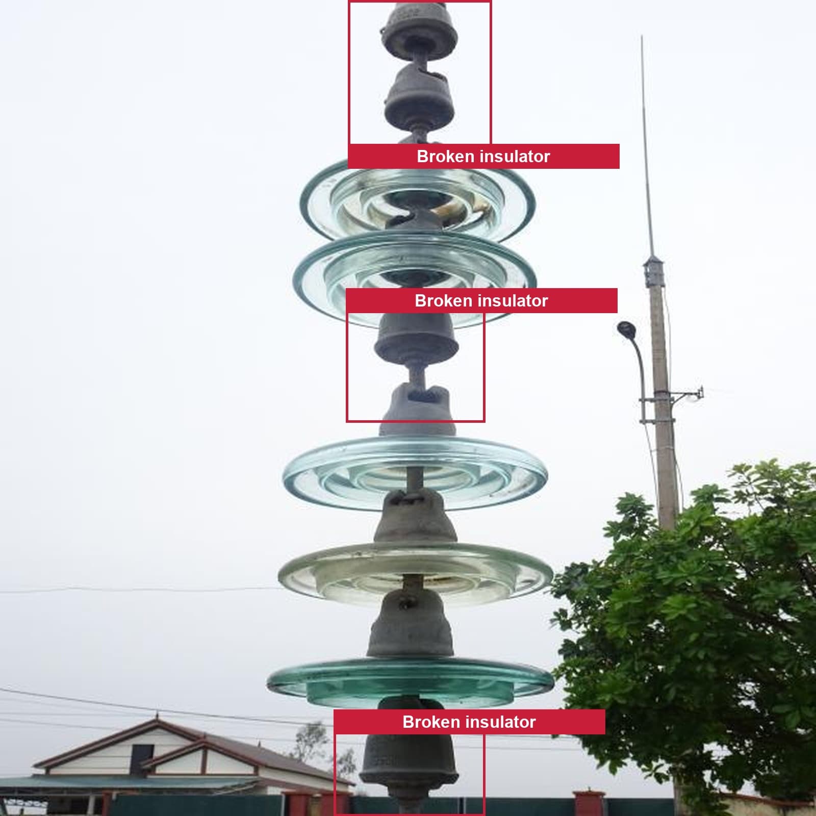 Annotated drone photograph of a glass cap-and-pin insulator string with three bounding boxes, each labelled Broken insulator.